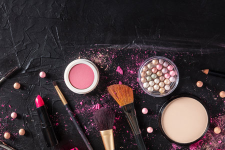 Make up products and tools, overhead flat lay shot on a black backgroundの写真素材