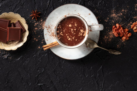 Hot chocolate with cinnamon, nuts, and copy space, shot from above