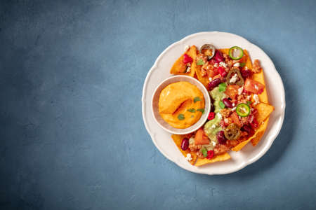 Nachos with chili con carne, guacamole and cheeseの写真素材