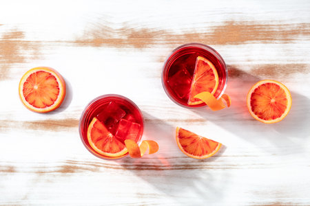 Negroni cocktails with blood oranges, overhead flat lay shot