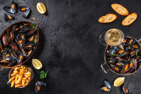 Mussels with wine, lemon, and French fries, overhead flat lay shotの写真素材