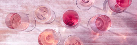 Rose wine panorama, various hues of wine in many wine glassesの写真素材