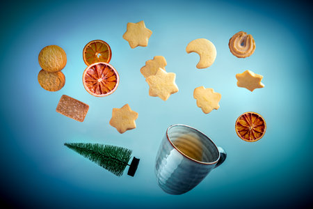 Danish butter cookies, a cup of tea and a Christmas tree, flyingの写真素材