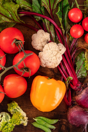 Organic vegetables background with tomatoes, bell peppers, beetroot and other food, shot from above....
