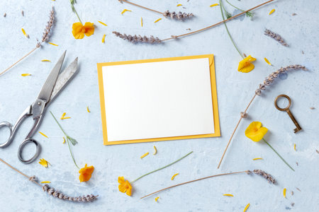 Spring wedding invitation or birthday card stationery mockup with flowers, overhead flat lay shot. A...