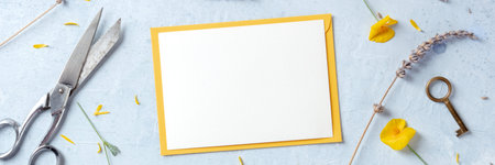 Summer or spring greeting card or invitation panorama with flowers, shot from above. Stationery...