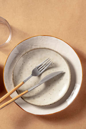 Modern ceramic plates with cutlery, shot from above with a place for text. Trendy dinner settingの写真素材