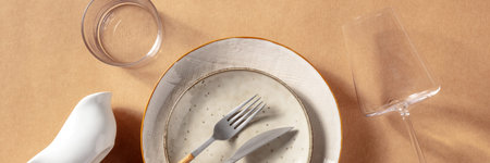 Modern tableware panorama. Ceramic plates, glasses, and cutlery, shot from the top. Panoramic header...