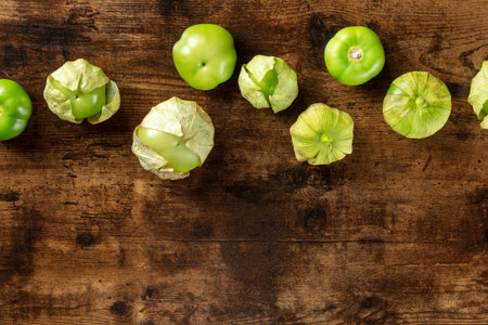 Tomatillos, green tomatoes, shot from the top with a place for text. Mexican food ingredient on a...