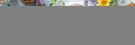 Tea panorama with herbs, flowers and fruit, shot from above. Healthy hot drink panoramic banner with orangeの写真素材
