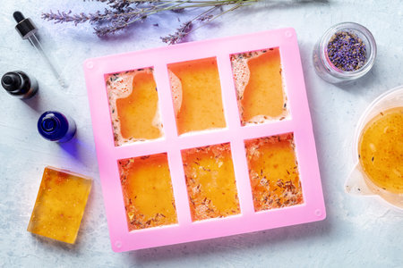 Organic handmade soap, the process of making, overhead flat lay shot. Liquid glycerin with lavender...
