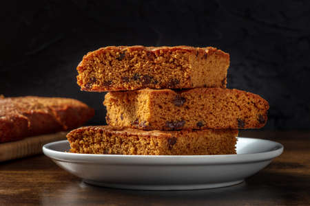 Blondie brownie dessert bars with chocolate chips, a close-up on a black backgroundの写真素材