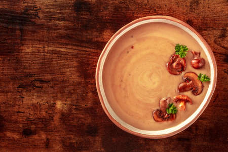 Mushroom soup, shot from above on a dark rustic wooden background with copy spaceの写真素材