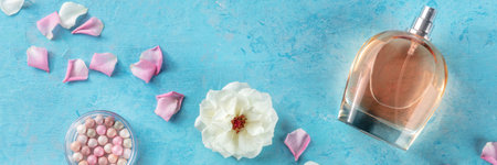 Beauty and fashion panorama. Perfume, makeup, and flowers, overhead flat lay shot on a blue...