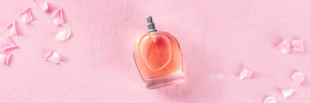 Rose fragrance panorama with fresh flower petals, top shot on a pink background, a minimalist...