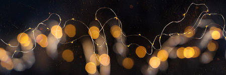 Fairy lights, blurred led garland panorama, overhead flat lay shot on a dark backgroundの写真素材