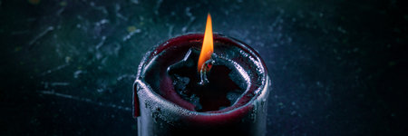 Burning candles on a dark background, mysterious ritual panoramaの写真素材