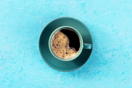 Coffee cup, overhead flat lay shot on a blue background, espresso drink on a turquoise tableの写真素材