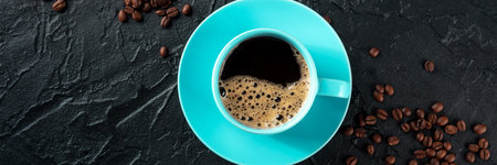Blue coffee cup and coffee beans panorama, overhead flat lay shot on a black stone background with copy space, a panoramic banner for a menuの写真素材