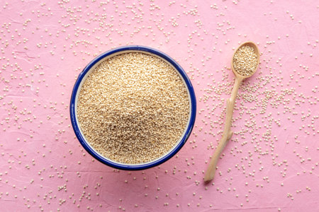 Quinoa in a bowl, healthy organic wood, uncooked, with a wooden spoon, top shotの写真素材