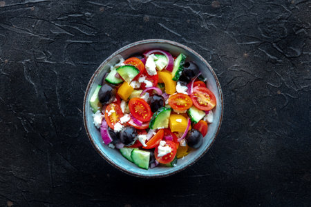 Greek salad. Fresh tomato, cucumber, bell pepper, Feta cheese, onion, and olives. Healthy summer food, overhead flat lay shotの写真素材