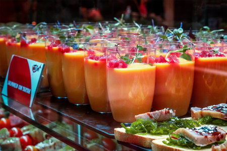 Gazpacho, traditional Spanish cold soup, served as a drink at a food market in Spain, with tapasの写真素材