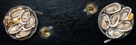 Fresh raw oysters on ice panorama, overhead flat lay shot with lemon and champagne, panoramic banner...