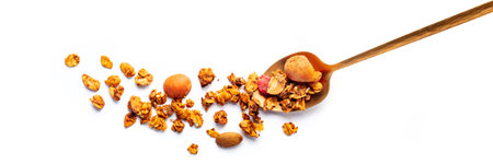 Granola in a spoon on a white background, panorama. Organic gourmet muesli, shot from the topの写真素材