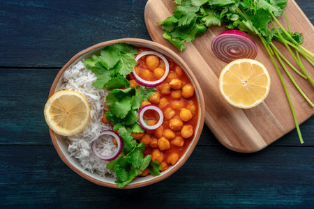 Chana masala, chickpea curry, traditional Indian dish, overhead flat lay shot with ingredientsの写真素材