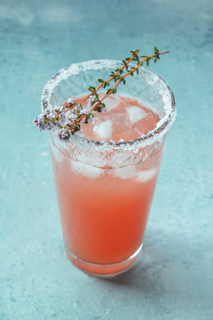 Salty Dog cocktail with fresh grapefruit juice, lime juice, and thyme, in a Collins glass with iceの写真素材