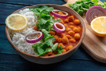 Chana masala, chickpea curry, traditional Indian dish,with ingredients on a rustic backgroundの写真素材