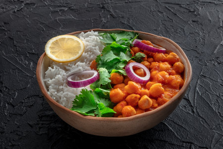 Chana masala, chickpea curry, traditional Indian dish, on a black backgroundの写真素材