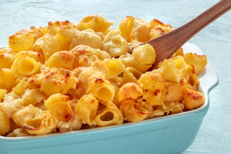 Mac and Cheese, macaroni pasta, oven-baked in a casserole with cream, freshly cooked, a close-upの写真素材