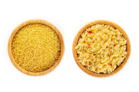 Millet, ancient African grain, dry and cooked, in wooden bowls on a white background, overhead flat lay shot. Healthy vegan side dishの写真素材