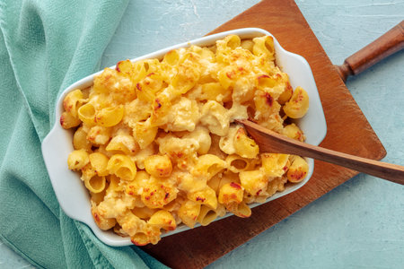 Mac and Cheese, macaroni pasta, oven-baked in a casserole with cream, homemade American dish, shot...