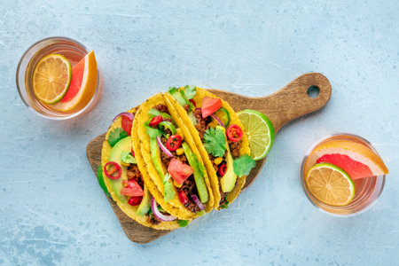 Tacos and Paloma cocktails, Mexican food and drink, overhead flat lay shot, with limesの写真素材