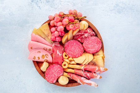 Italian Antipasti tray. Charcuterie platter with cheese and deli meats, overhead flat lay shotの写真素材