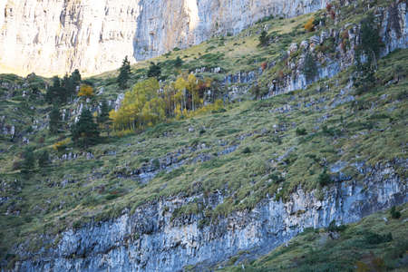 steep cliffs with some green in the torla ordesa national park in spainの写真素材