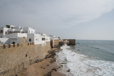 kids jumping from the medina wall into the oceanの写真素材