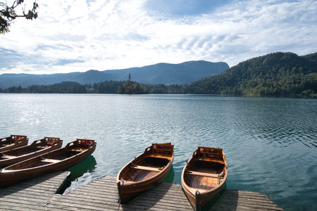 Wooden boats at beautiful Bled Lake in Slovenia in Octoberの写真素材