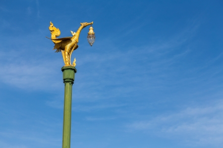 Golden bird lantern on the top of pole の写真素材