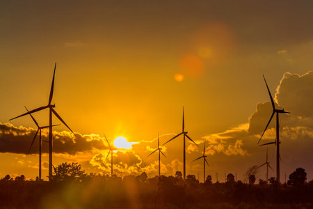 Wind turbine power generator silhouette at sunset