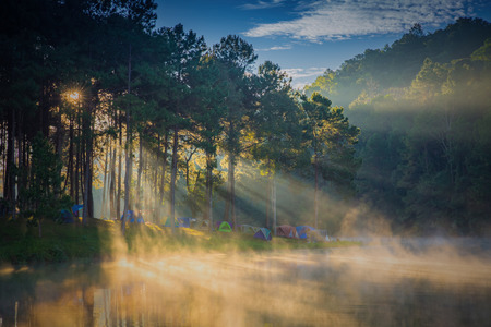 Dome tents beside the lake in the mist at sunrise at Pang Ung (Pang Tong reservoir), Mae Hong Son province, Thailandの写真素材
