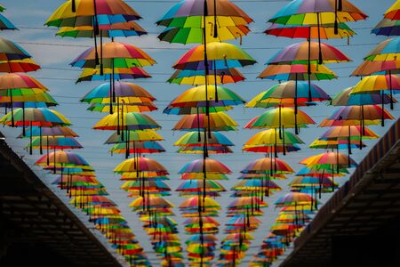 Colorful umbrellas background. Colorful umbrellas in the sky. Street decorationの写真素材