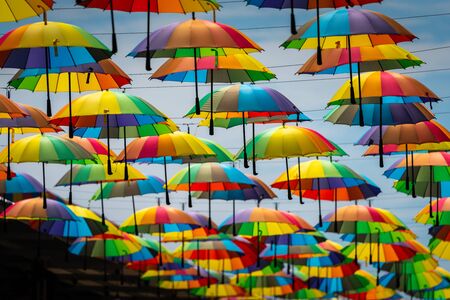 Colorful umbrellas background. Colorful umbrellas in the sky. Street decorationの写真素材