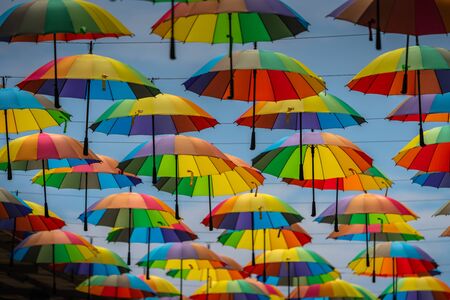 Colorful umbrellas background. Colorful umbrellas in the sky. Street decorationの写真素材