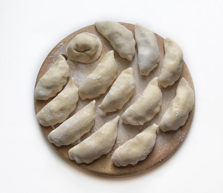 dumplings dumplings on a wooden circle.の写真素材