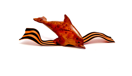 The diving dolphin with the St.George's Ribbon on a white background.の写真素材