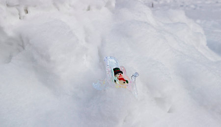 New Year's toys make the way through the Russian snow home after New Year's and Christmas holidays.の写真素材