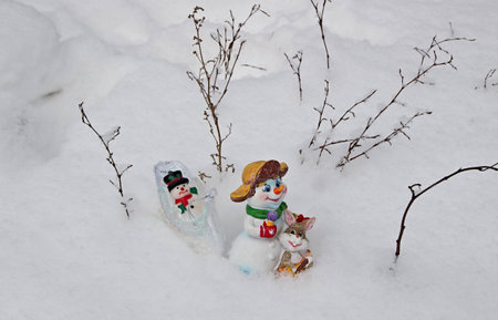 Children's Christmas tree decorations go on deep snow home after Christmas holidays.の写真素材